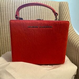 Brandon Blackwood mini Kendrick trunk in burnt orange pony hair